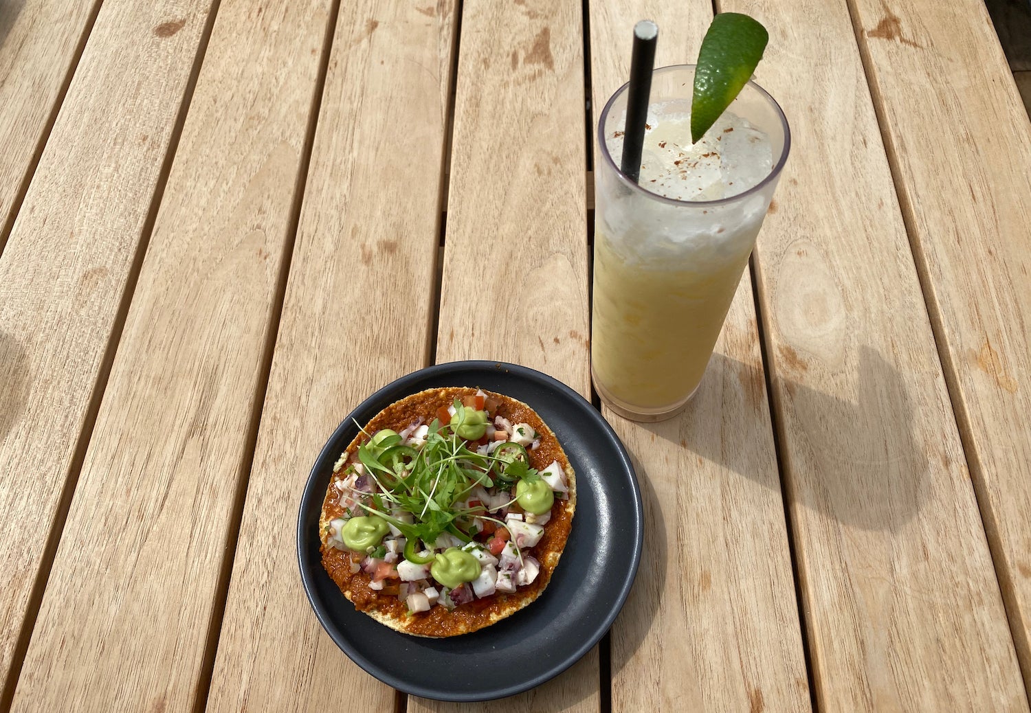 Octopus torta and a virgin pina colada on a table