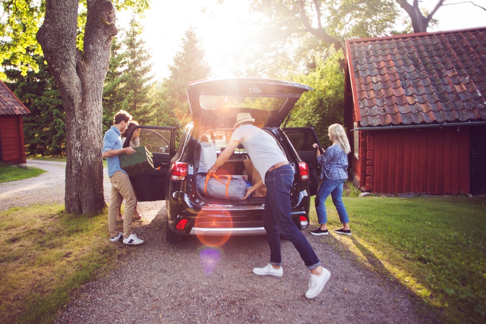Family loading car for road trip