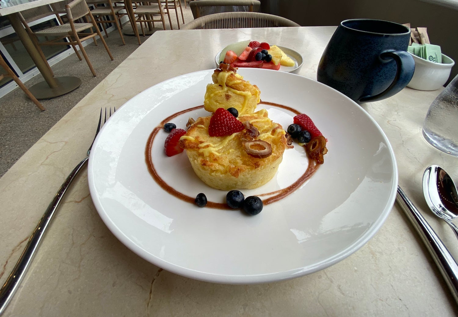 French toast on a plate covered in berries