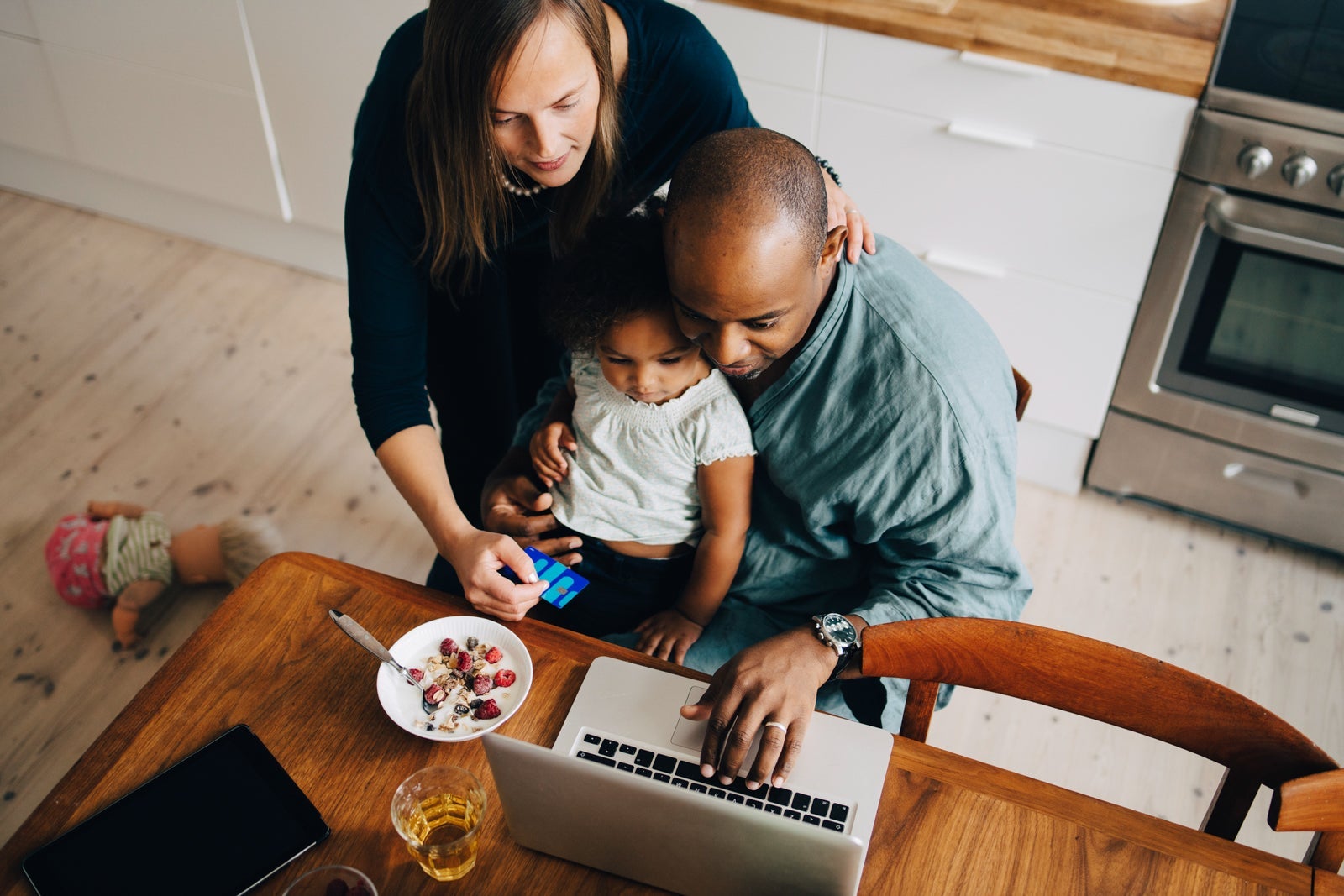 A family at a table with a laptop