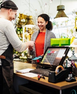 Florist Serving Customer At Cash Register