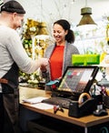 Florist Serving Customer At Cash Register