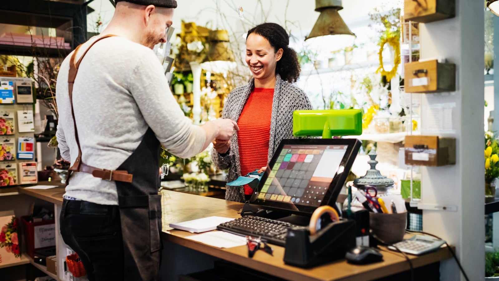 Florist Serving Customer At Cash Register