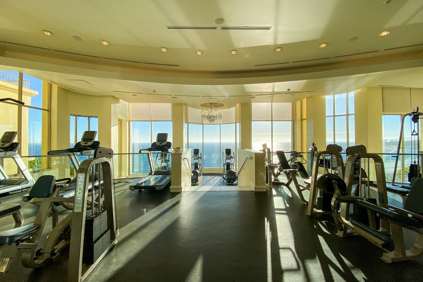 Equipment-packed hotel gym overlooking the ocean