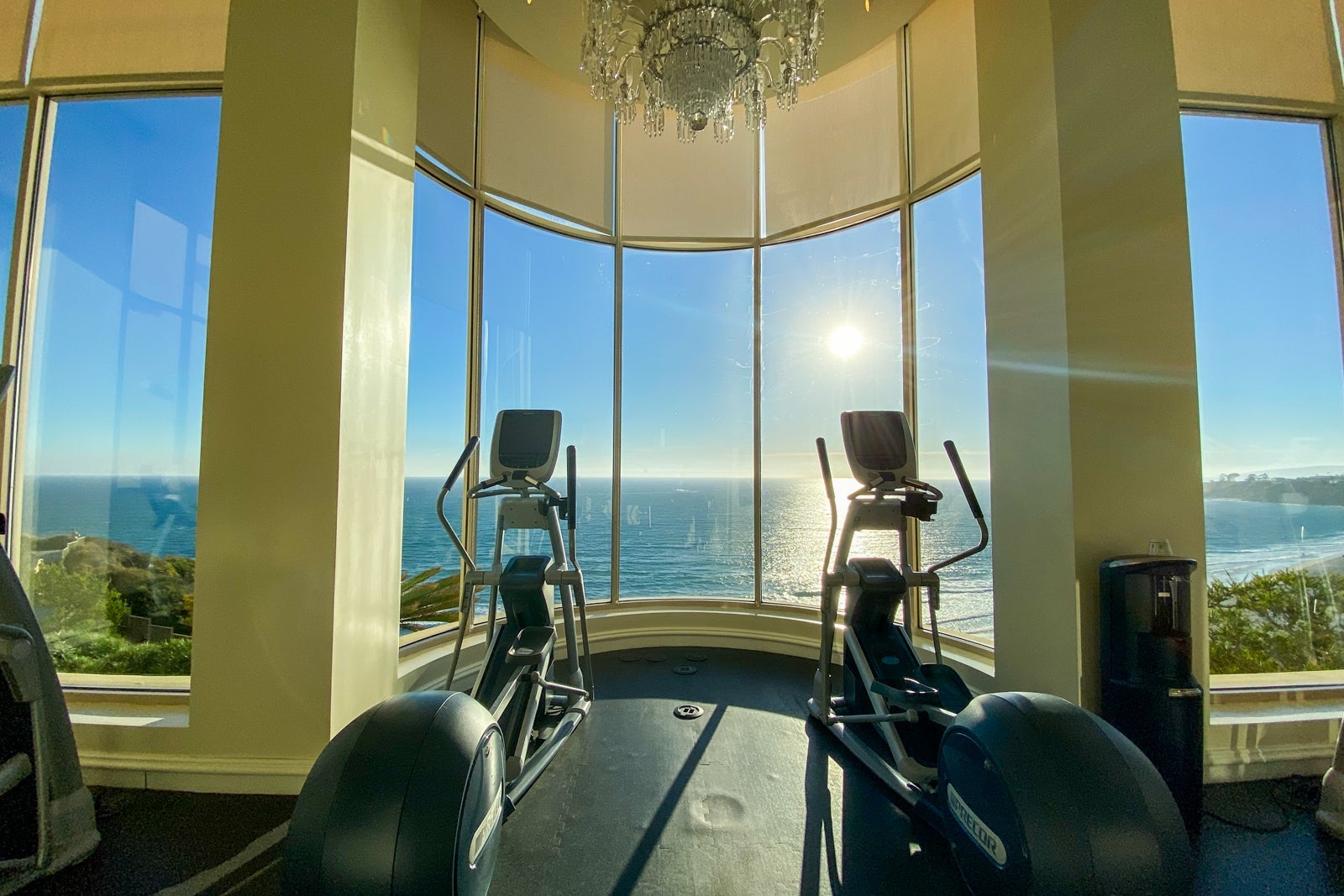 Stationary bikes in hotel gym overlooking the ocean