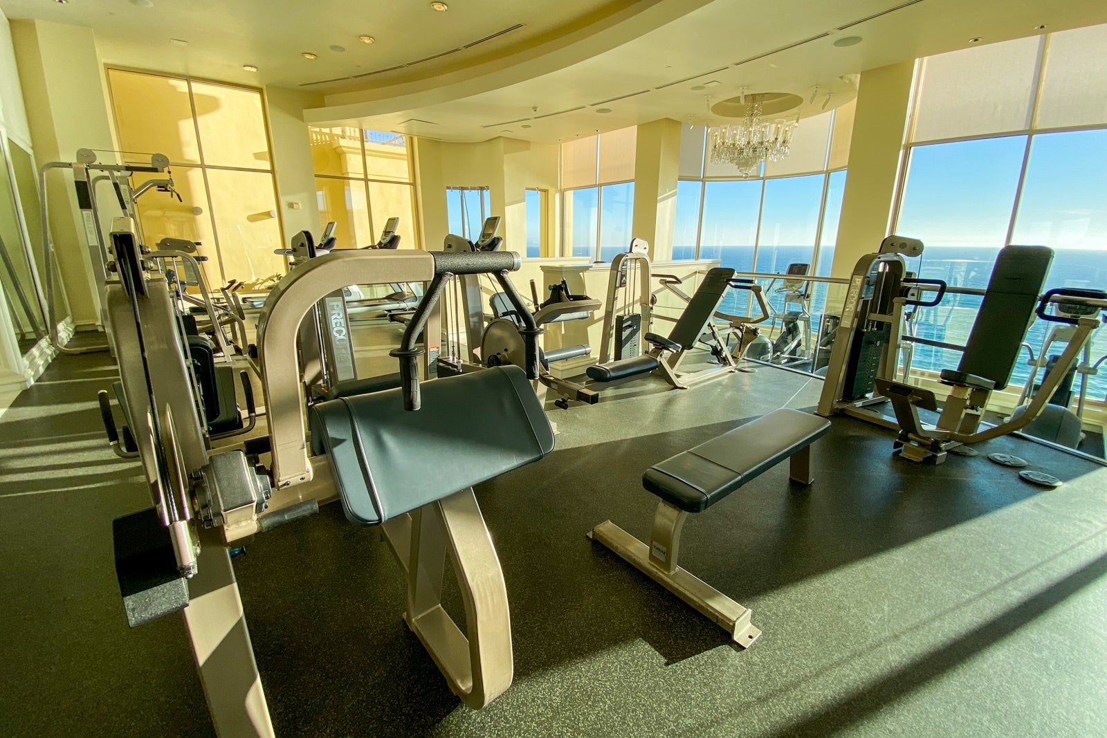 Equipment-packed hotel gym overlooking the ocean