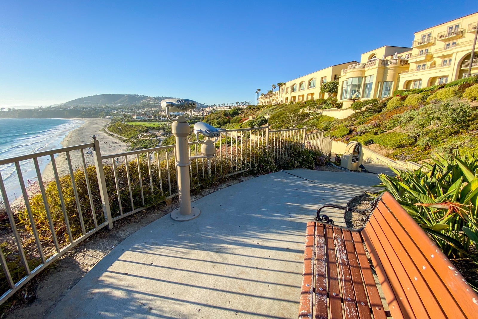 Side-view of hotel building overlooking landscaped grounds and the pacific ocean