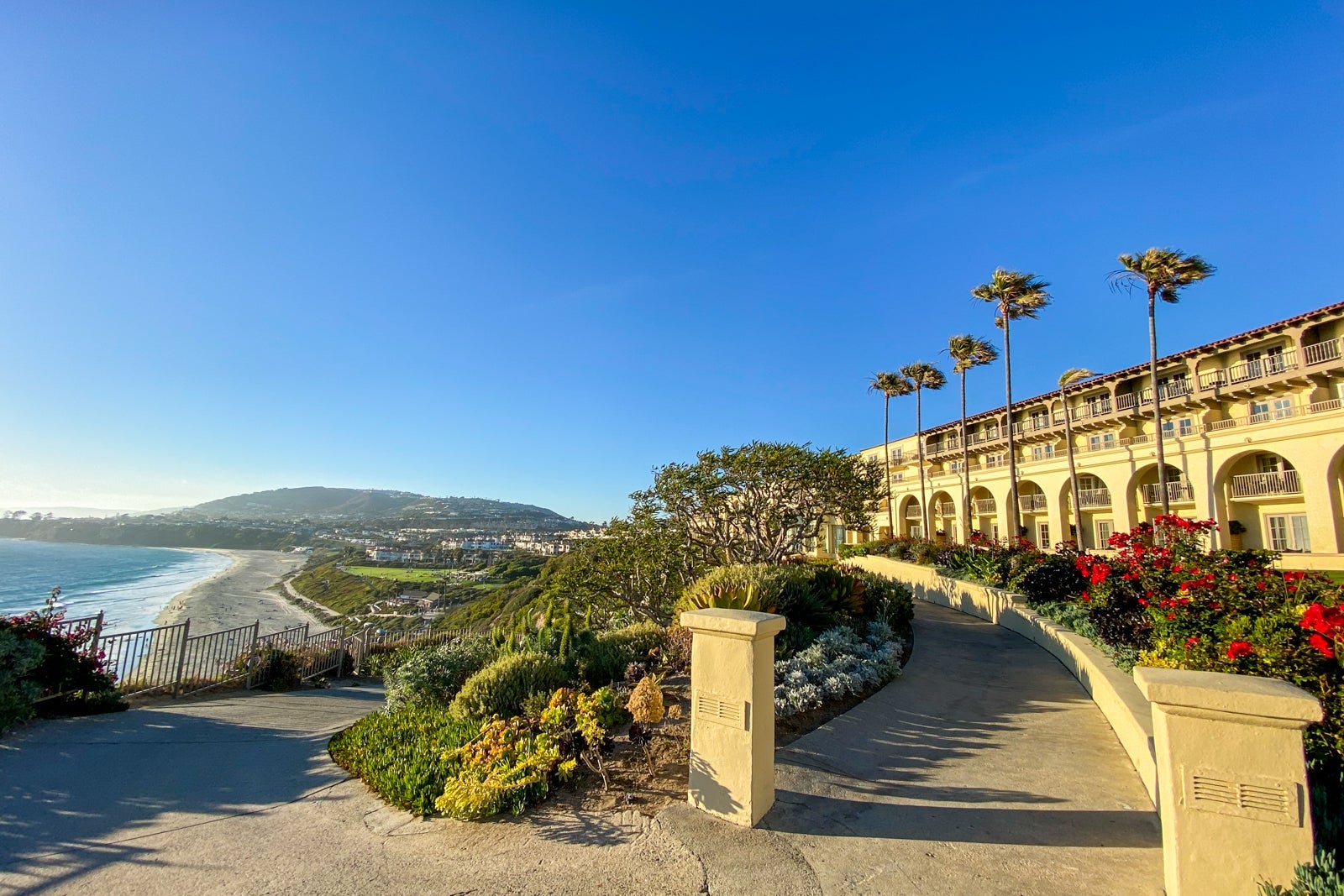 Side-view of hotel building overlooking landscaped grounds and the pacific ocean