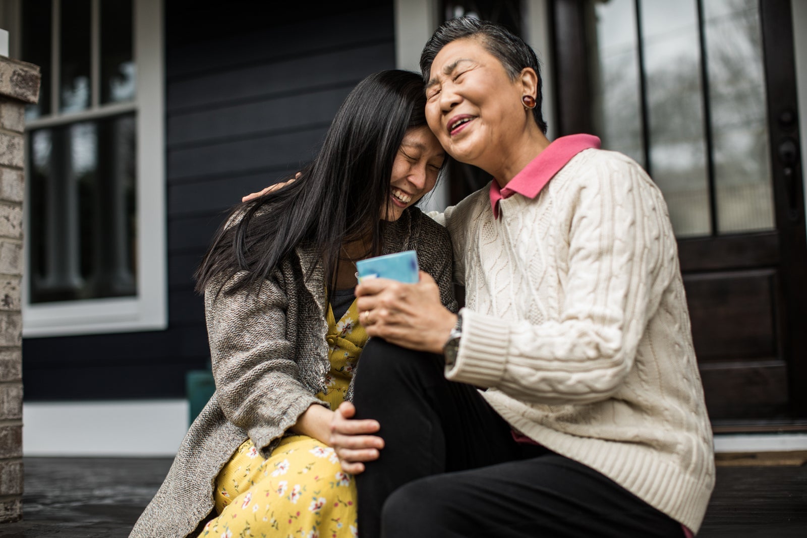 Two asian women embracing. Seemingly grandmother and granddaughter.