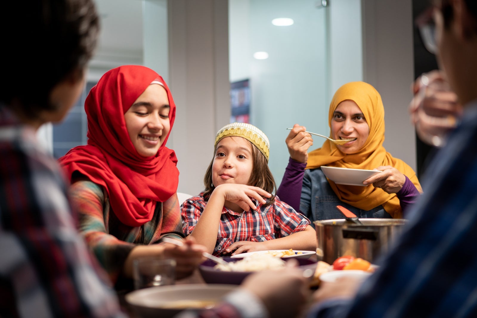 Muslim family enjoying a meal together.