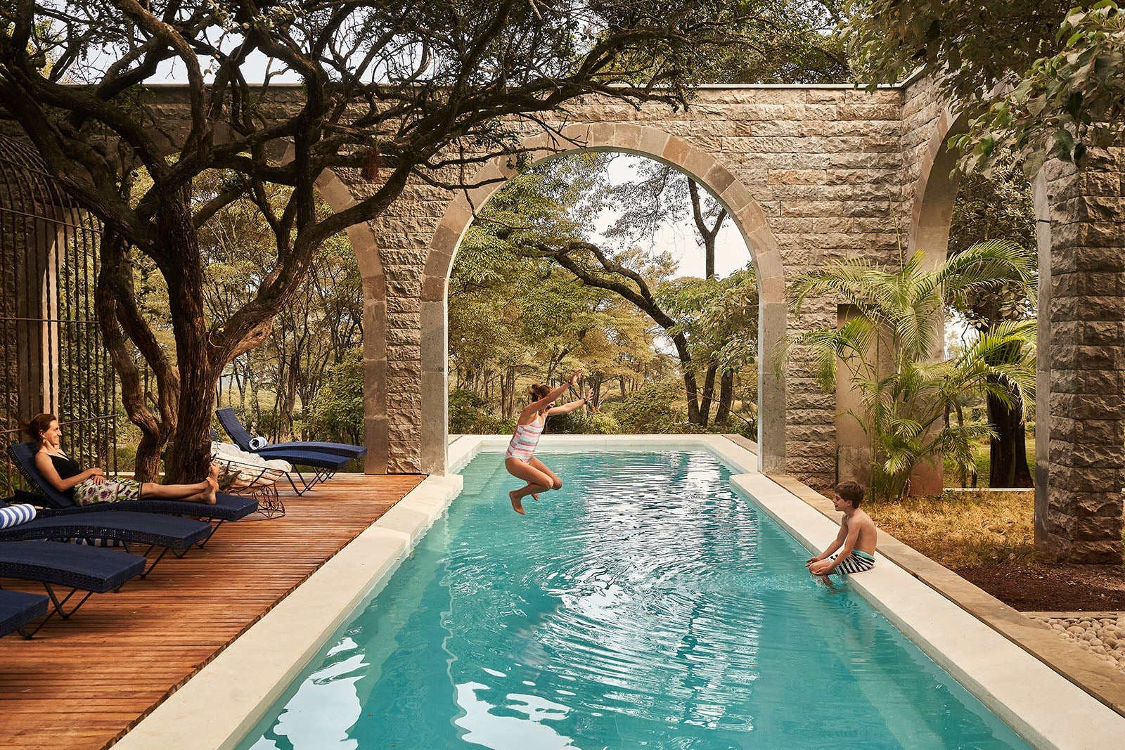 Kids playing in swimming pool at The Retreat at Giraffe Manor