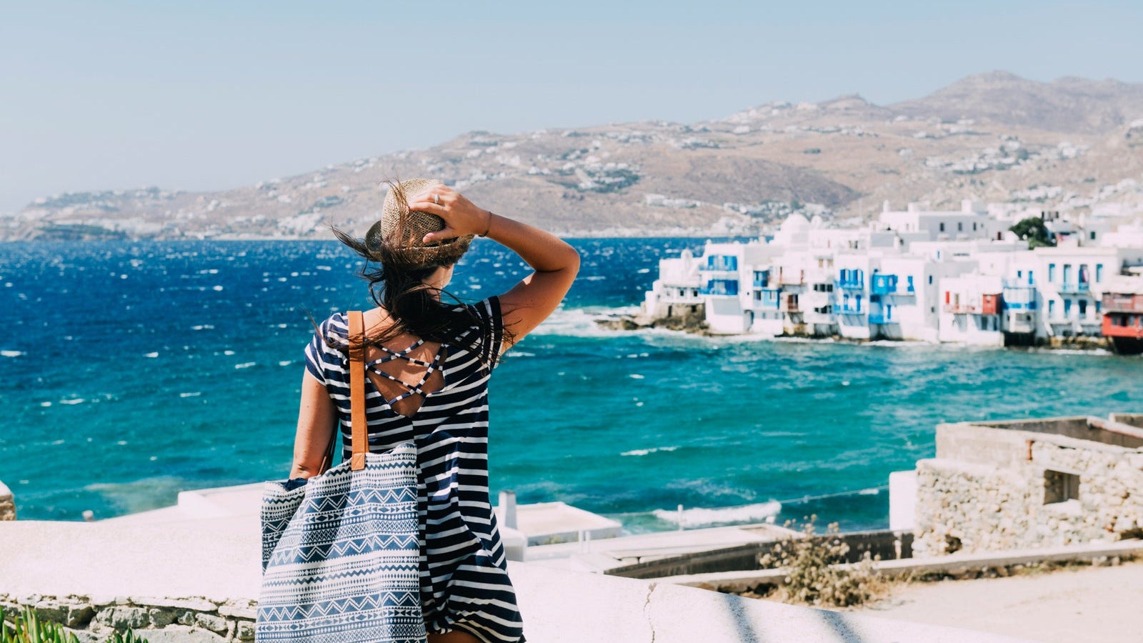 Greece, Mykonos, back view of tourist looking to Little Venice