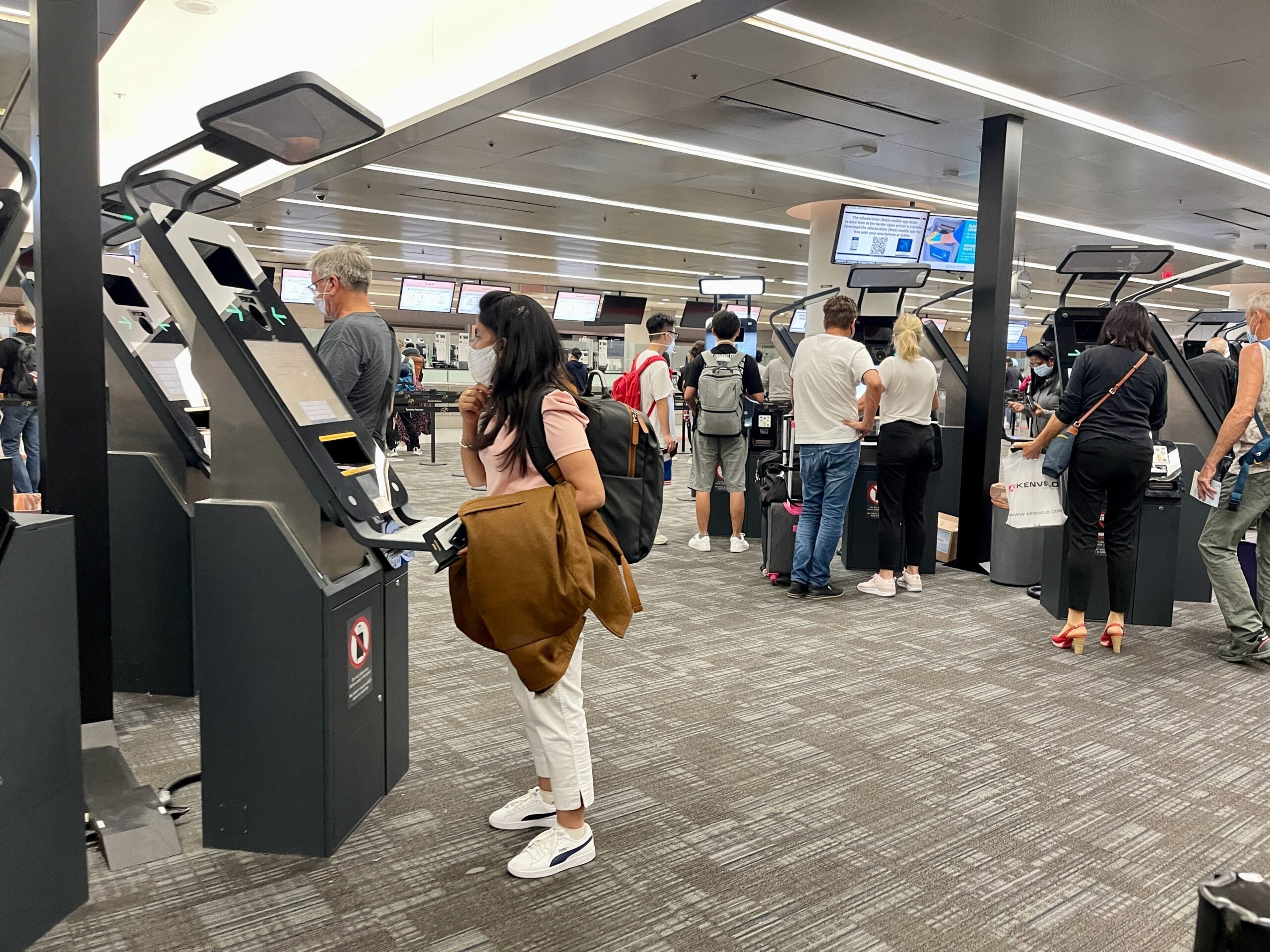 People using border kiosks