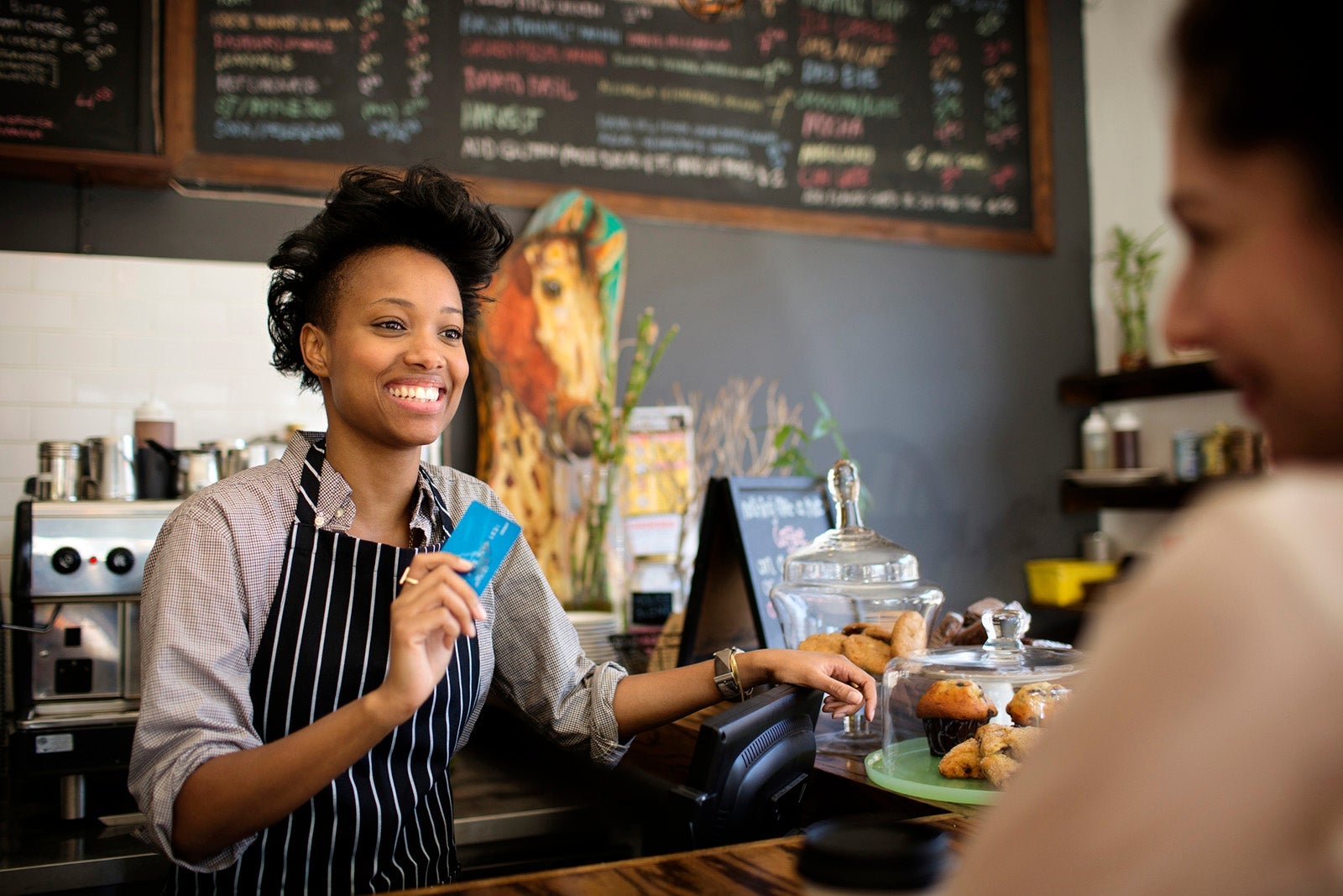 Woman paying at a cafe
