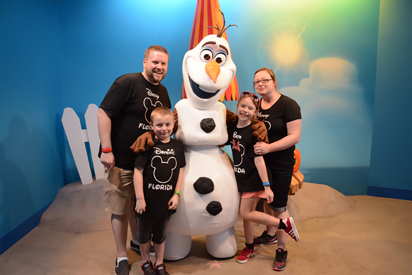 Family wearing matching Disney T-shirts