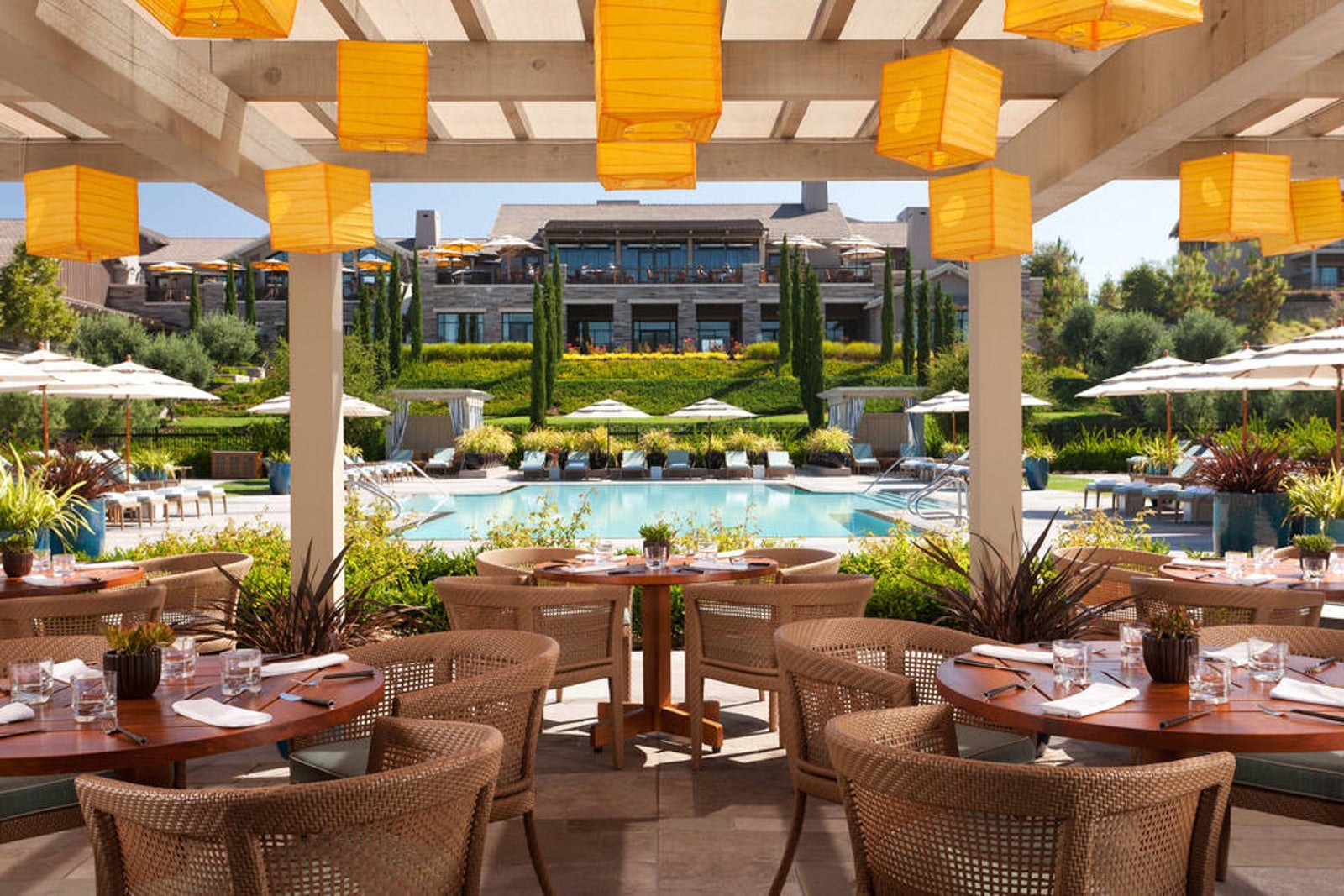 A photo of the patio overlooking the pool at Rosewood Sand Hill.