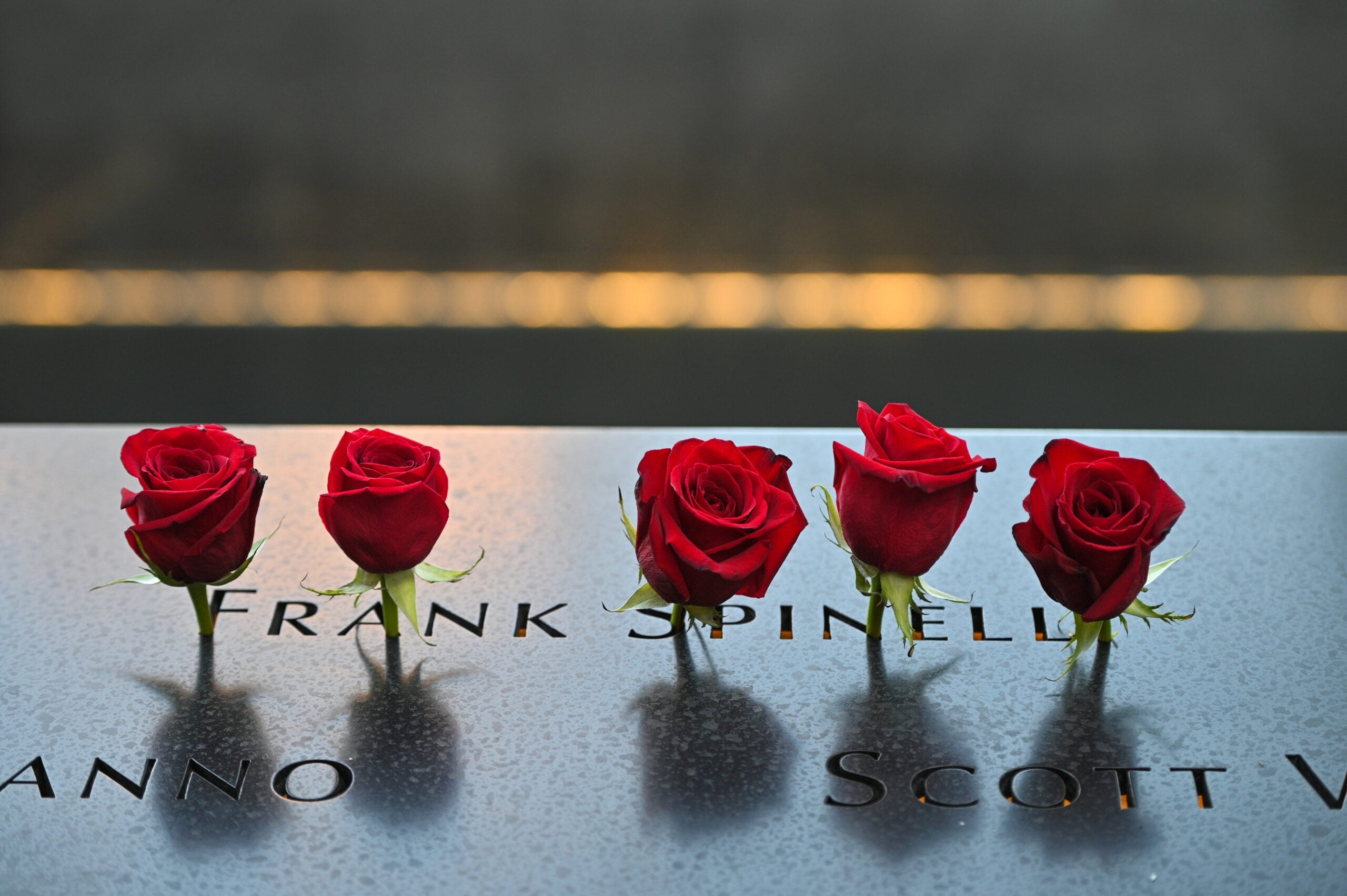 NEW YORK, NEW YORK - SEPTEMBER 11: Roses are placed at the name of Frank Spinelli during a ceremony at the National September 11 Memorial & Museum commemorating the 20th anniversary of the September 11th terrorist attacks on the World Trade Center on September 11, 2021 in New York City. The nation is marking the 20th anniversary of the terror attacks of September 11, 2001, when the terrorist group al-Qaeda flew hijacked airplanes into the World Trade Center, Shanksville, PA and the Pentagon, killing nearly 3,000 people. (Photo by Anthony Behar - Pool/Getty Images)