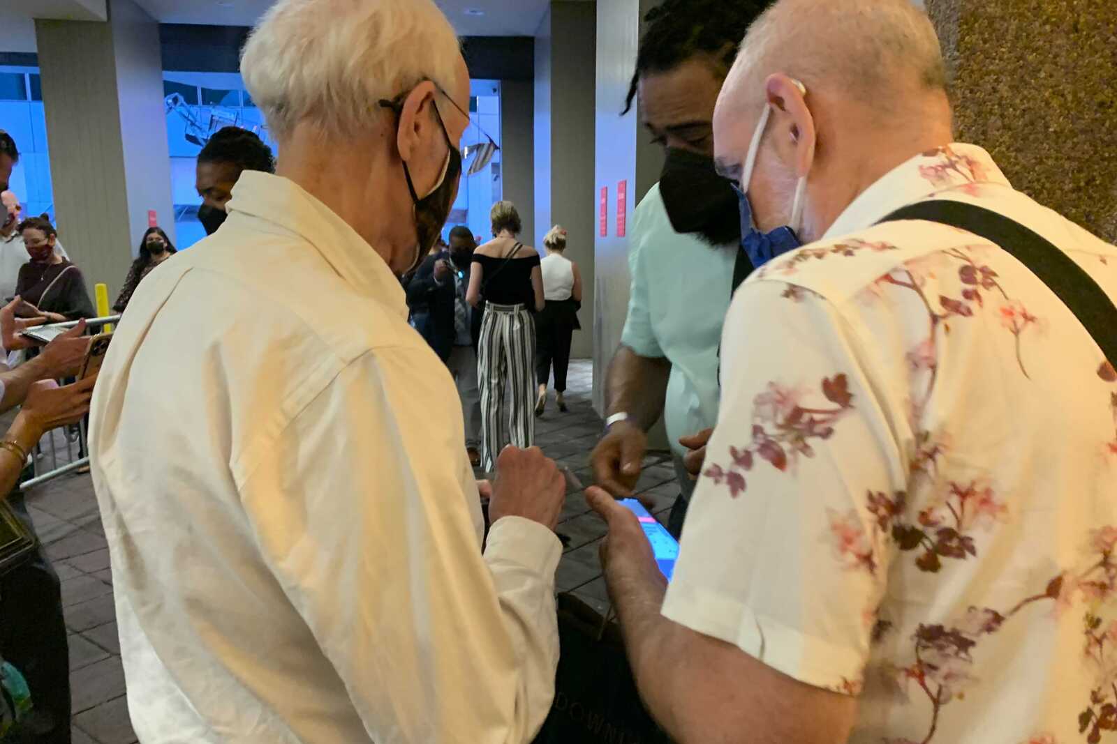 Couple getting their proof of vaccination checked before heading in to see Hadestown