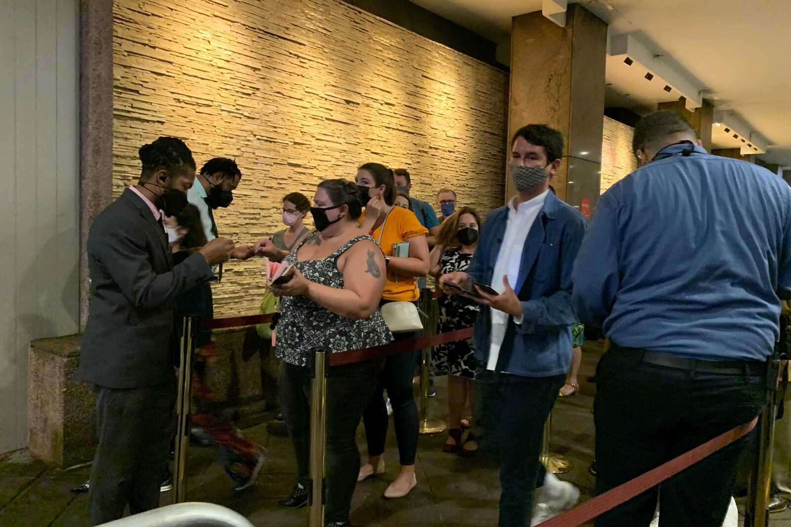 Guests wait in line to get their proof of vaccination checked on Broadway's reopening night