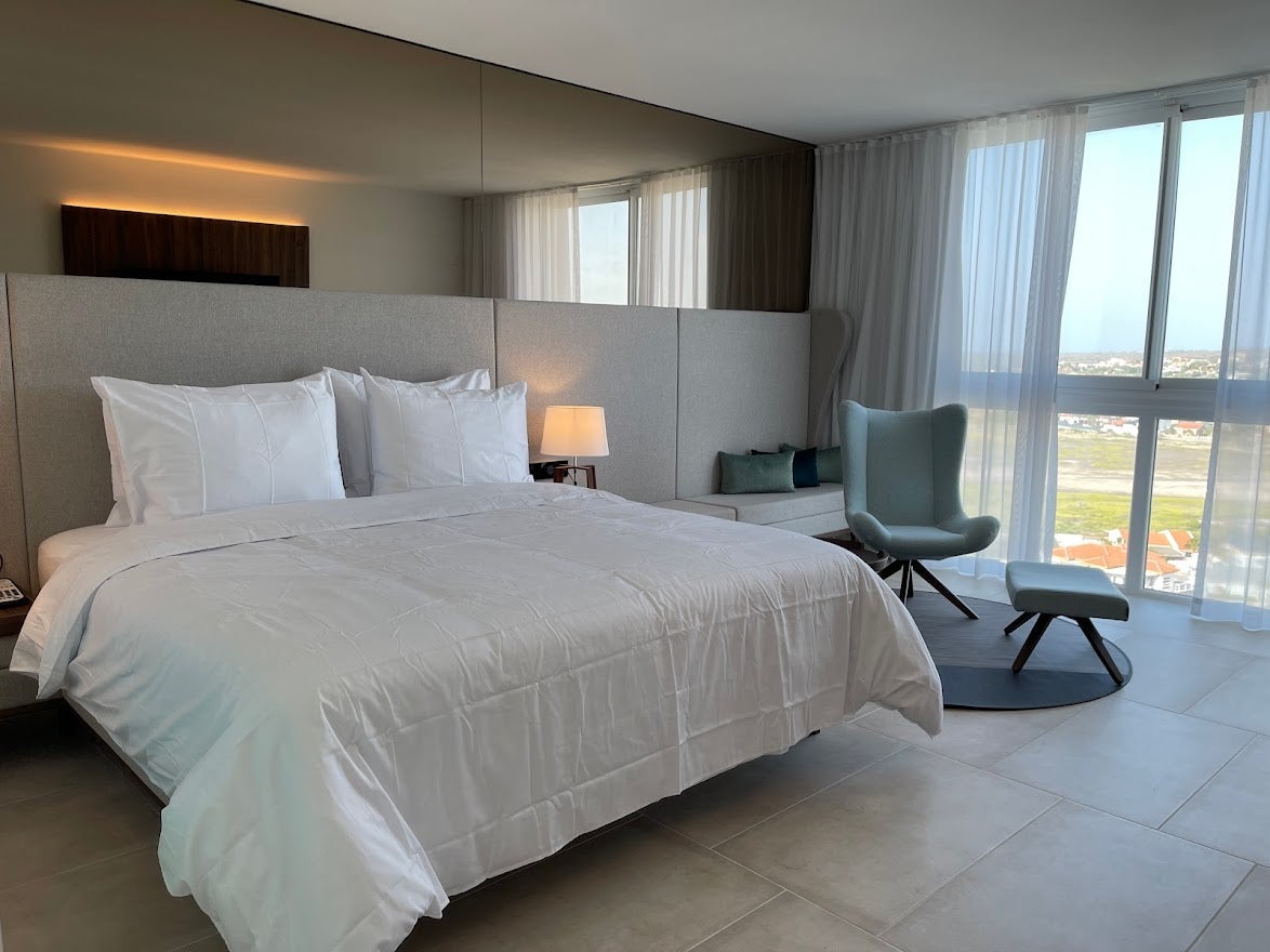 Bed and sitting area in a room at the Radisson Blu Aruba
