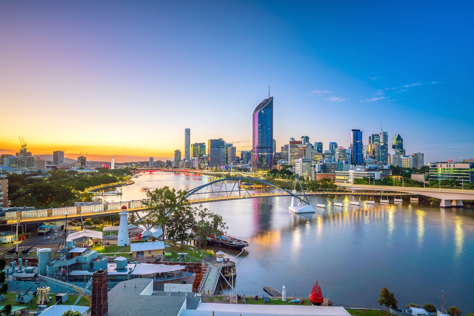 Brisbane skyline at dusk with skyscrapers lighting up