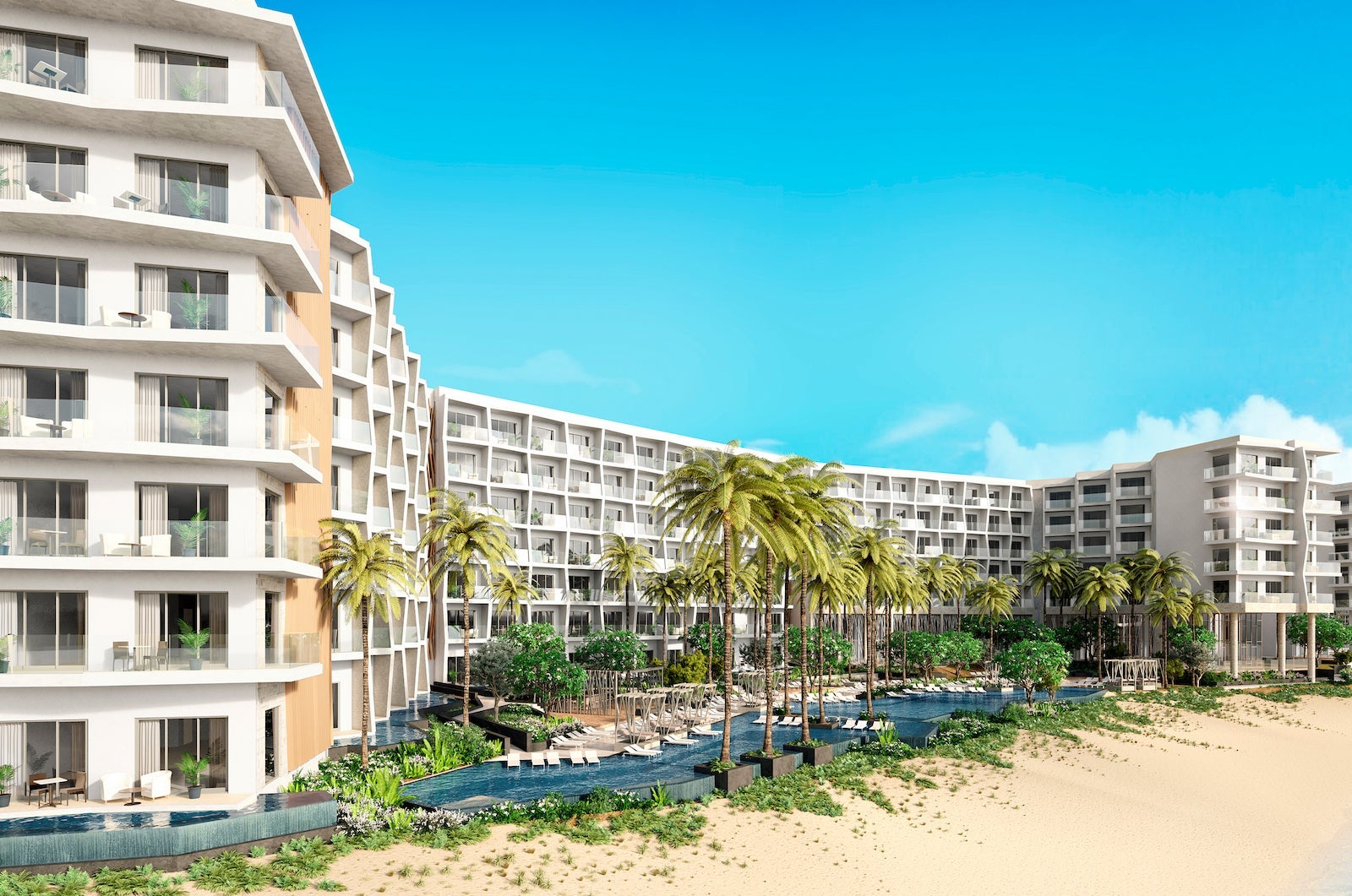 large white tropical resort with swimming pool and palm trees next to beach