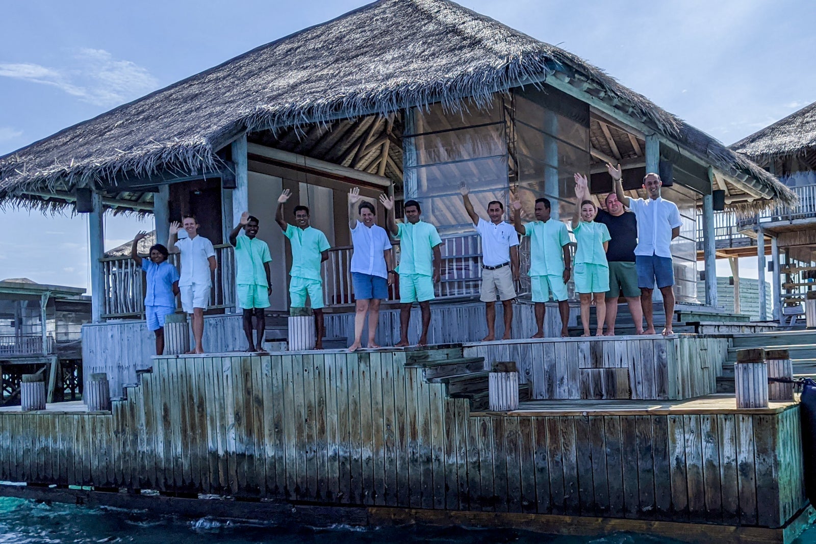 Six Senses Laamu staff waving goodbye