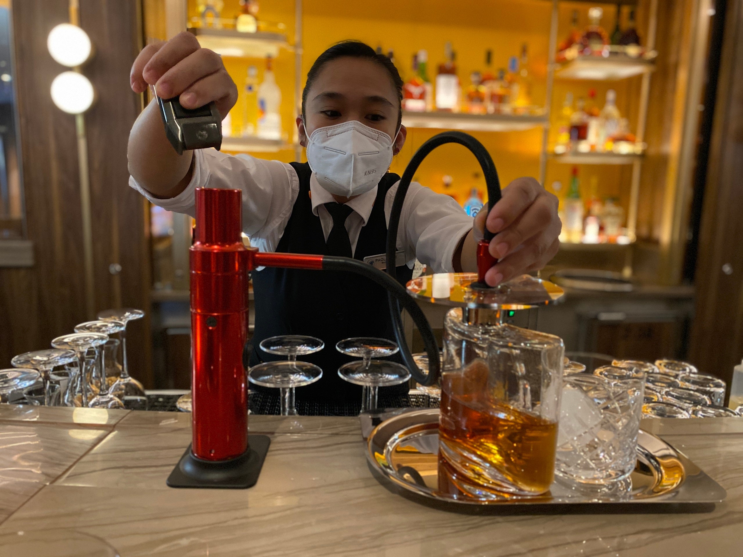 A bartender making the Rotterdam VII cocktail at the Half Moon Bar on Holland America's Rotterdam