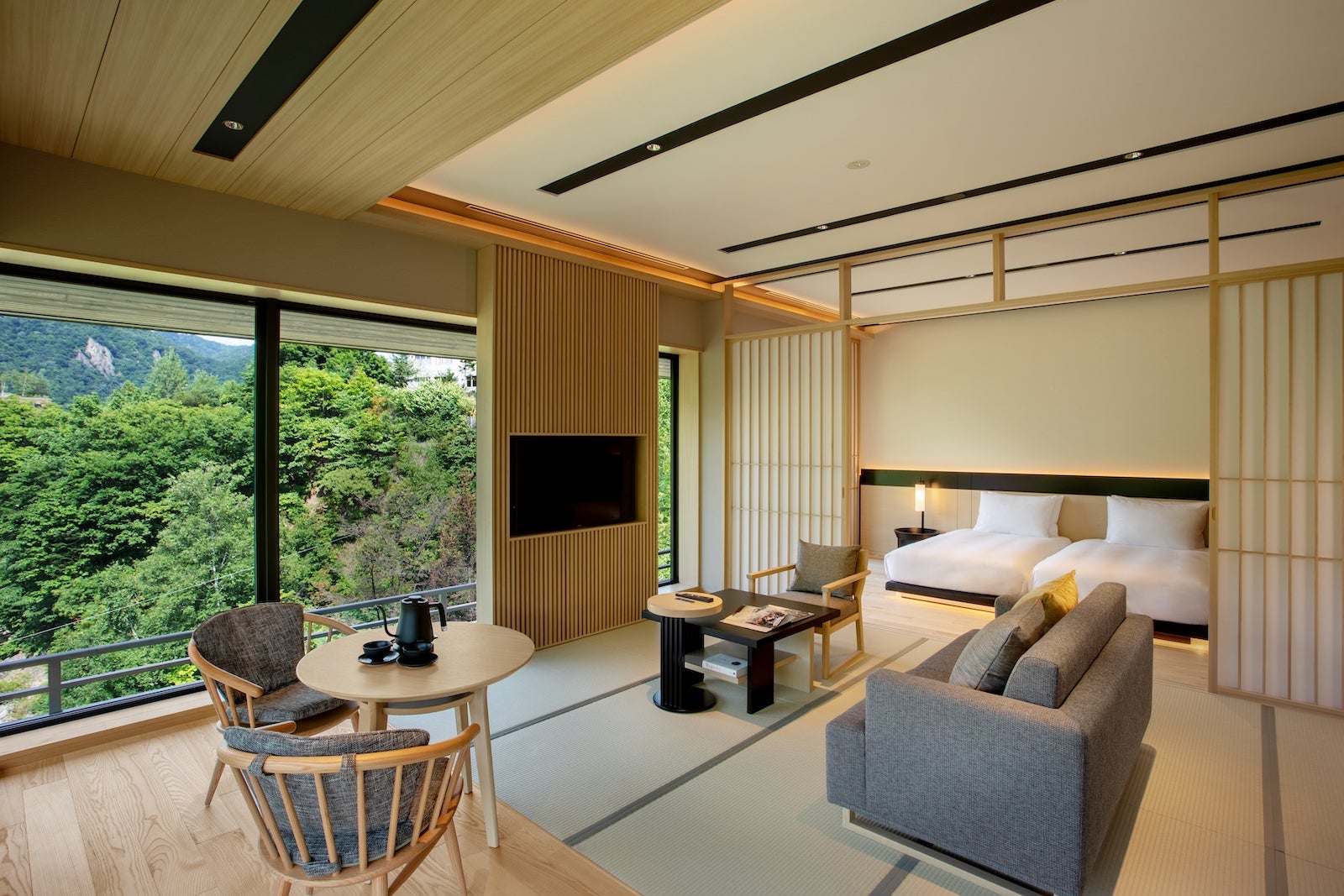 large room with Japanese design, two beds, couch and table