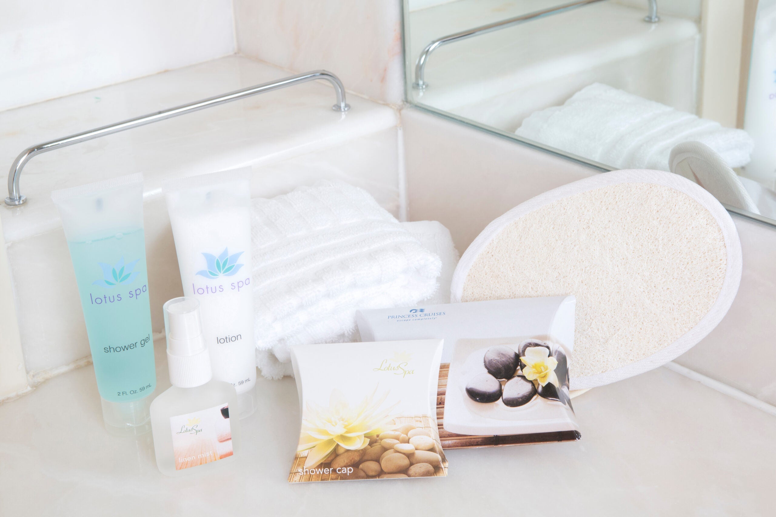 Various toiletry products and bottles on a bathroom sink with a mirror in the background