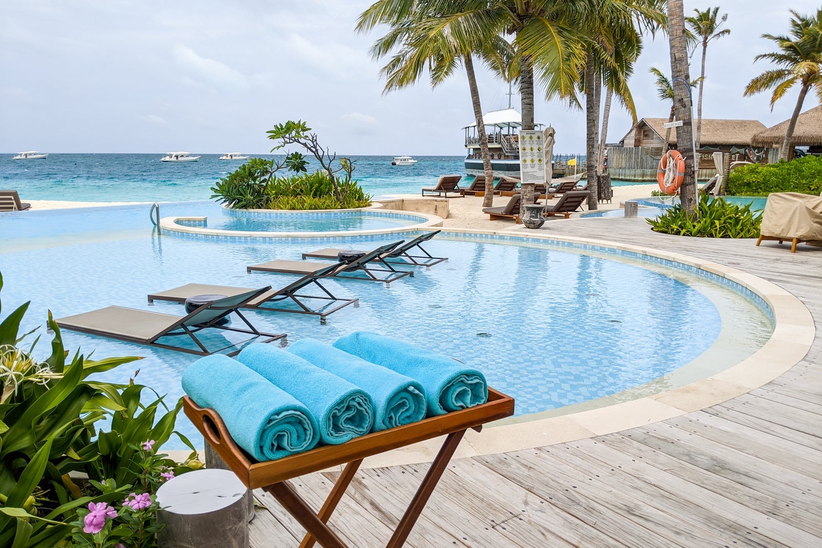 a hotel pool near an ocean