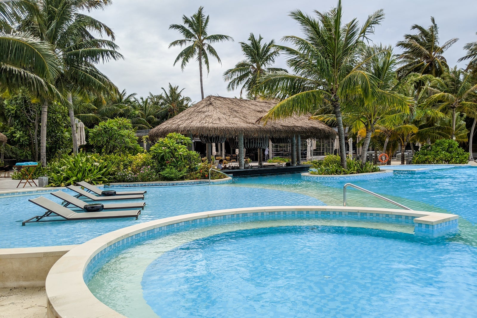 huts behind a hotel pool