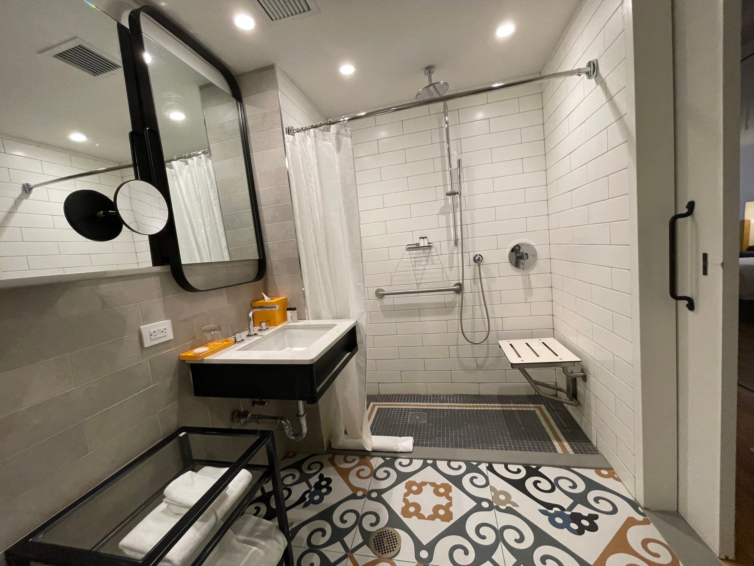 Roll in shower with fold-down bench and pull-under sink