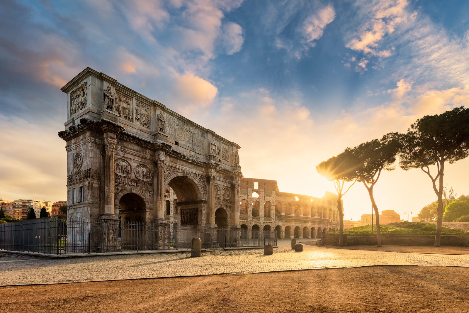 Arch of Constantine with the Colosseum in the background at sunrise, Rome, Lazio, Italy