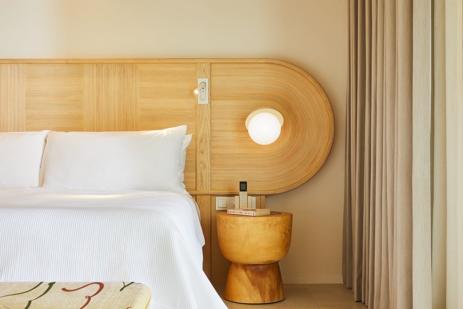 large wood headboard with rounded end, lamp built in and side table