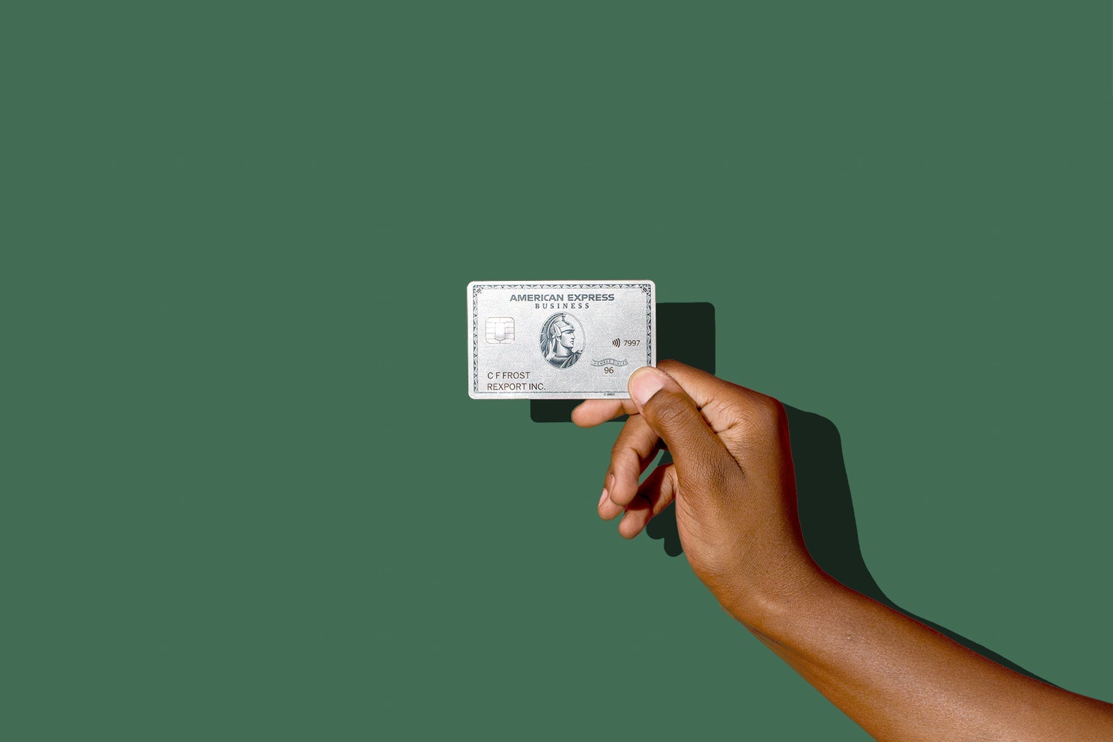 a hand holds a credit card