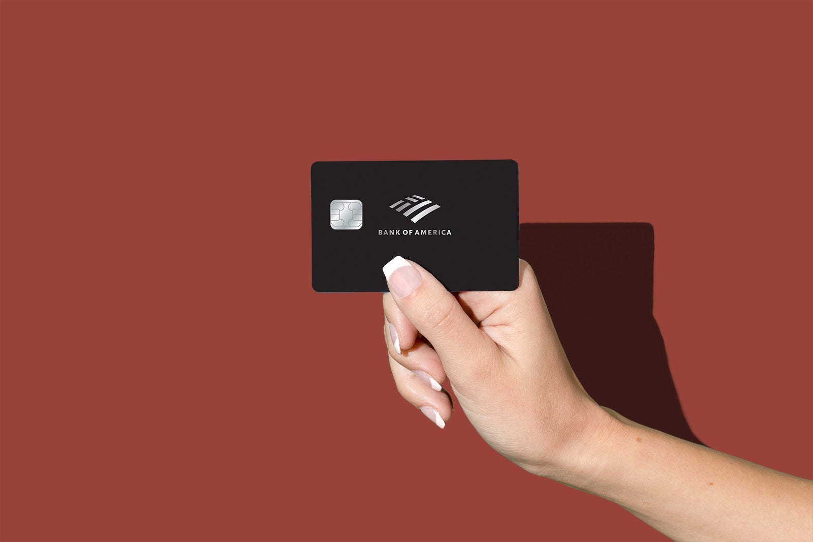 A hand holding the BoFA Premium Elite card