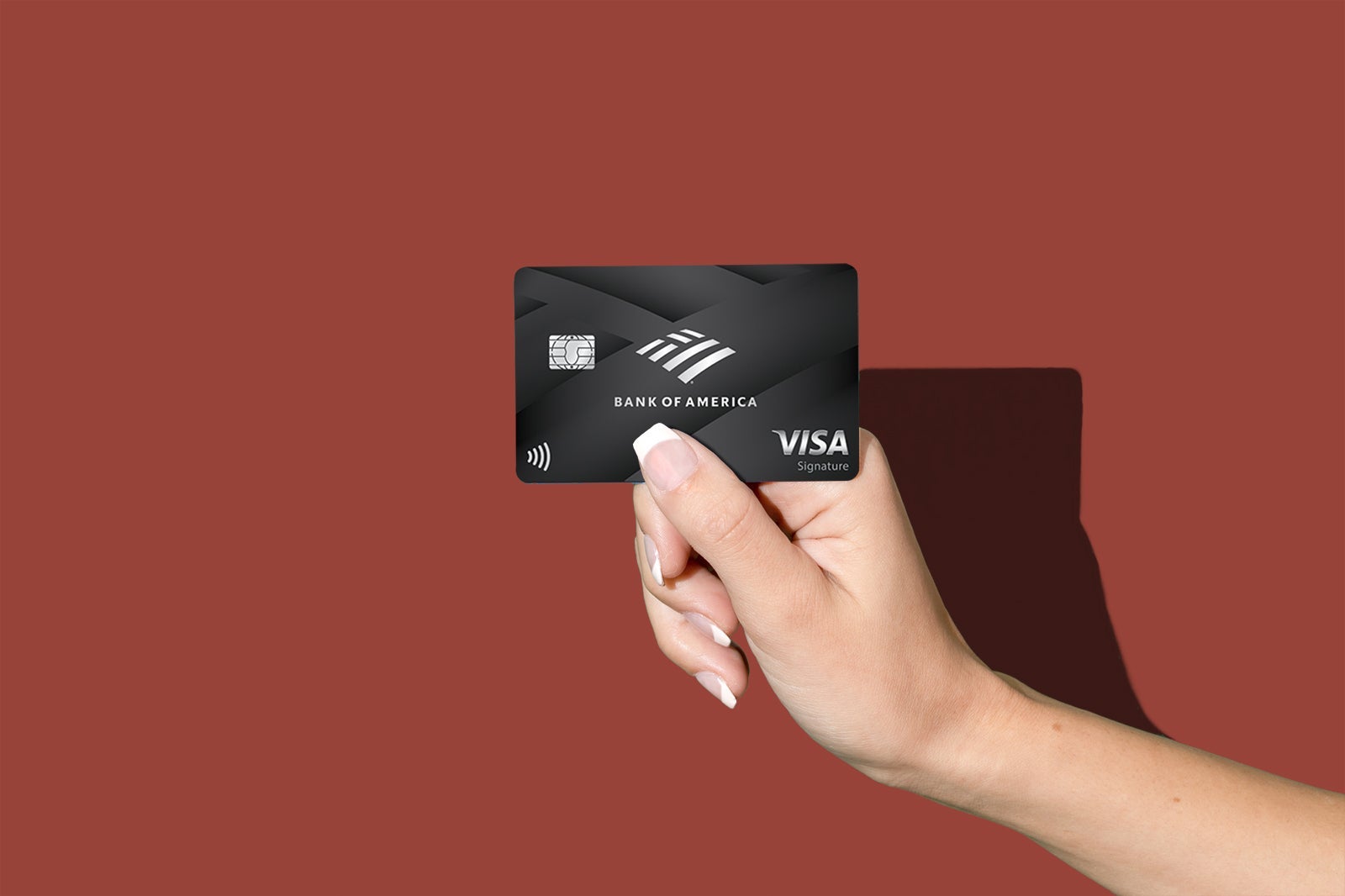 a hand holds a credit card