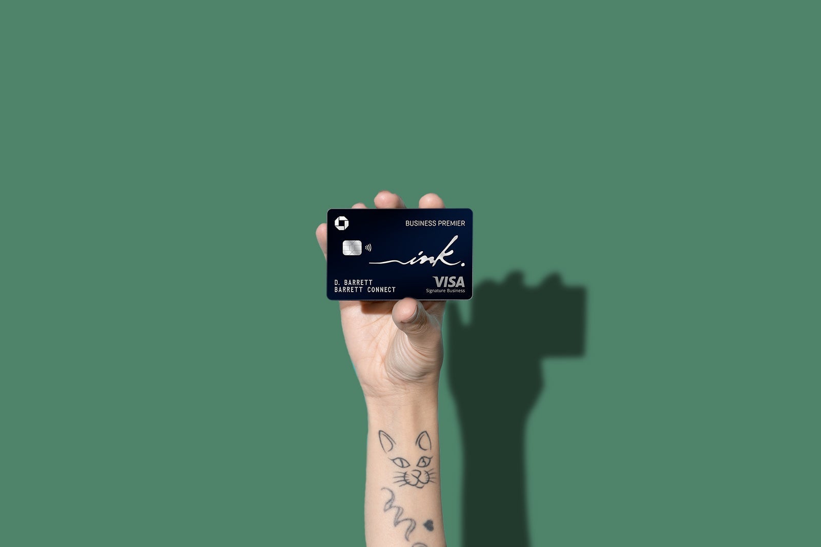 a hand holds a credit card