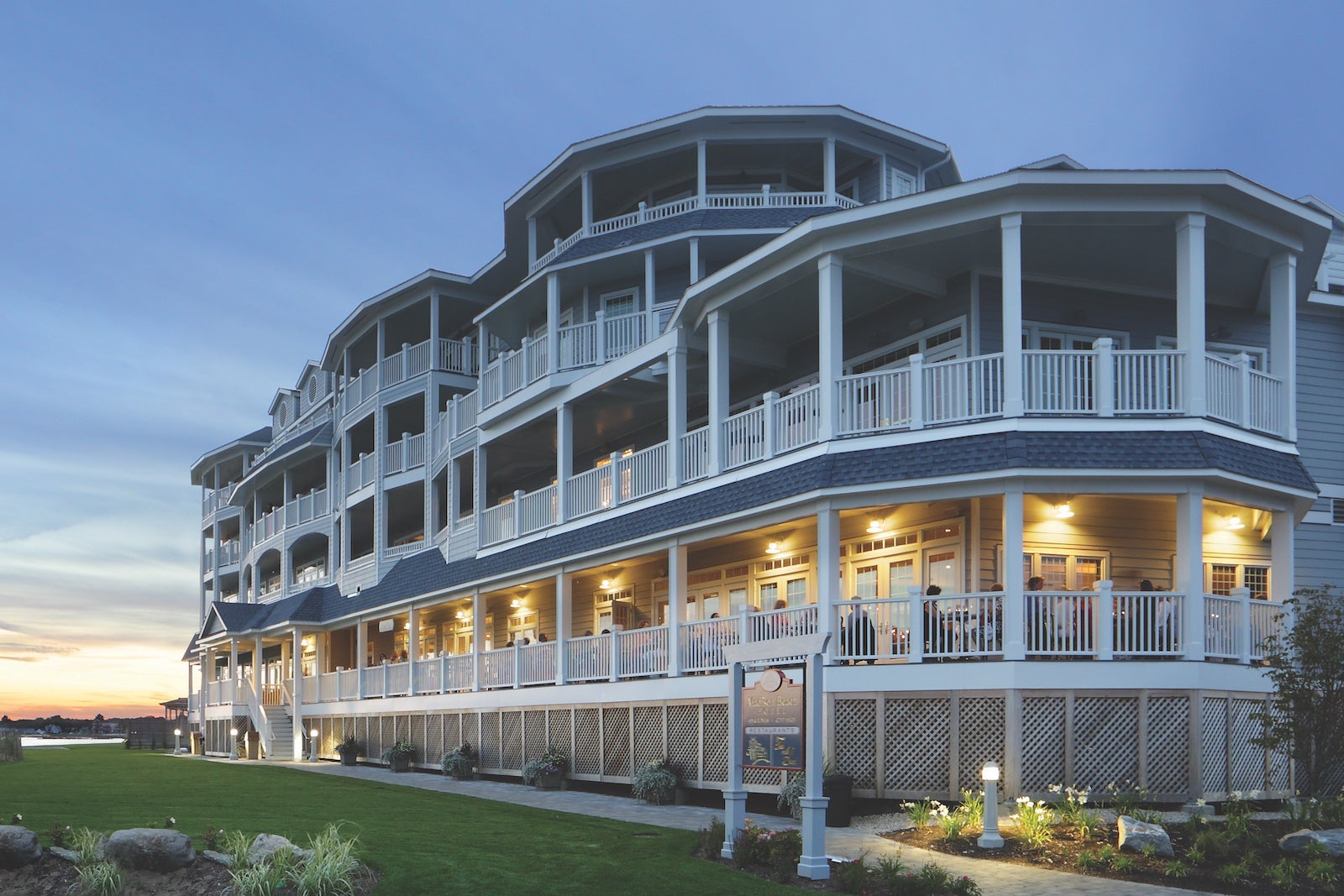 exterior of beach hotel with covered balcony and wrap-around porch
