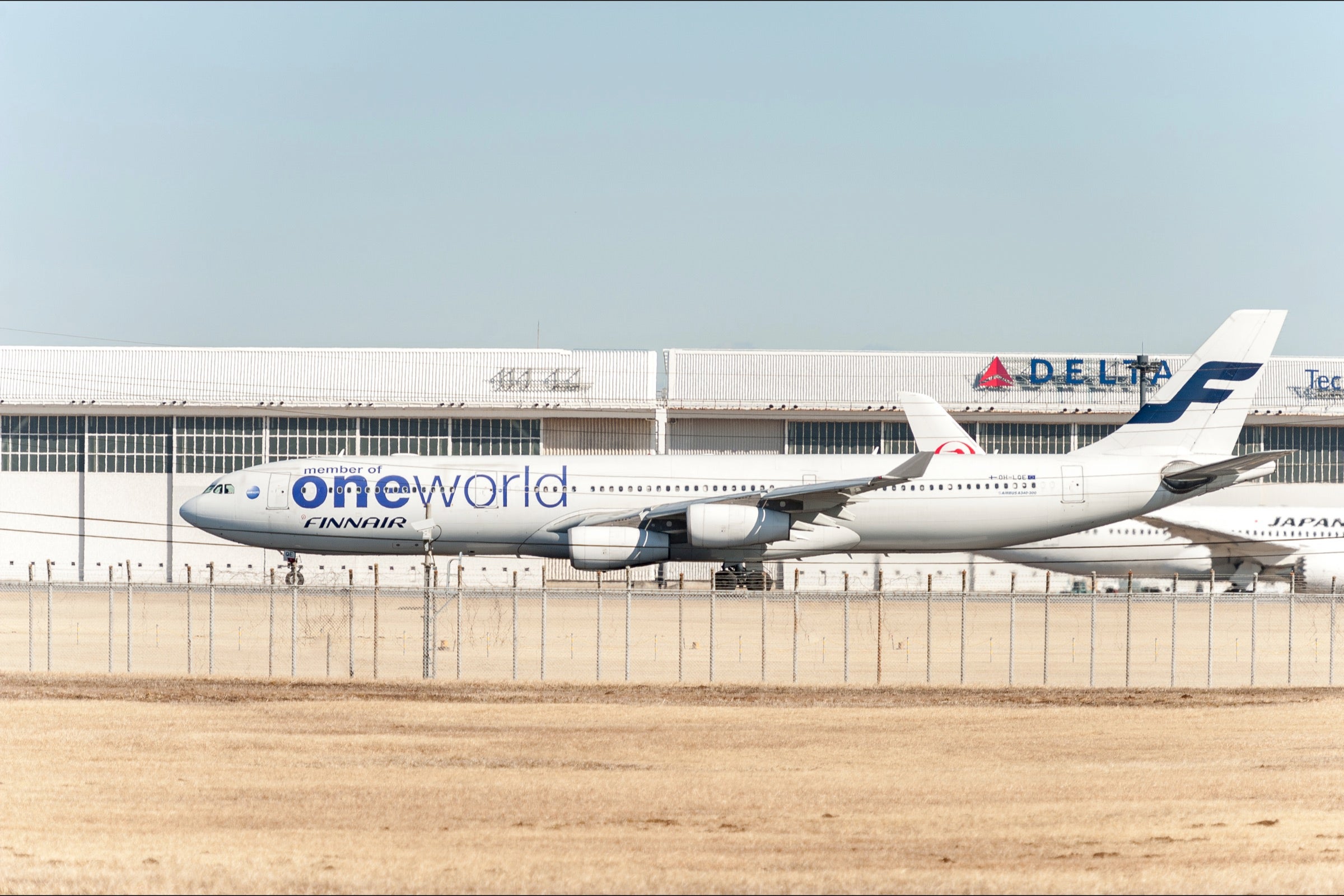 Finnair plane with a Oneworld livery on the ground in Tokyo