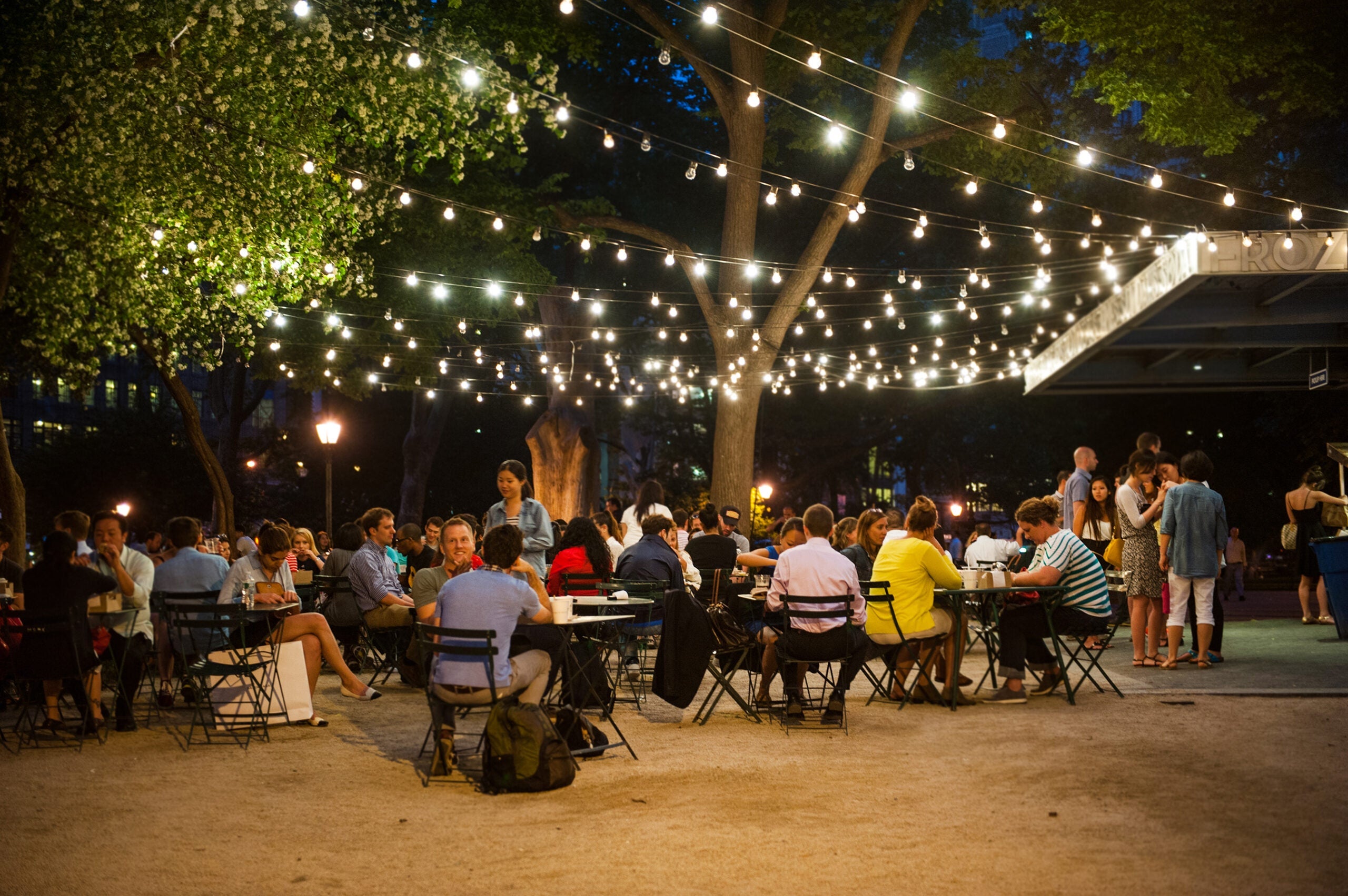 People dining outside at a Shake Shack location in New York City