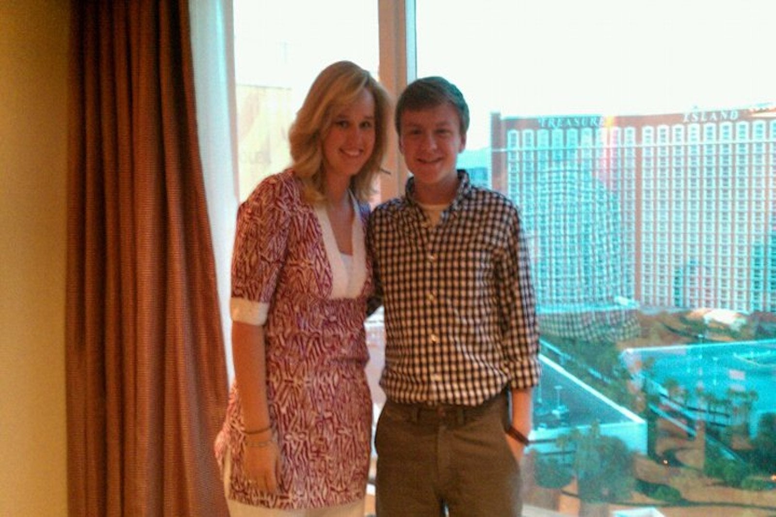 teenage boy and girl standing in window overlooking Las Vegas strip