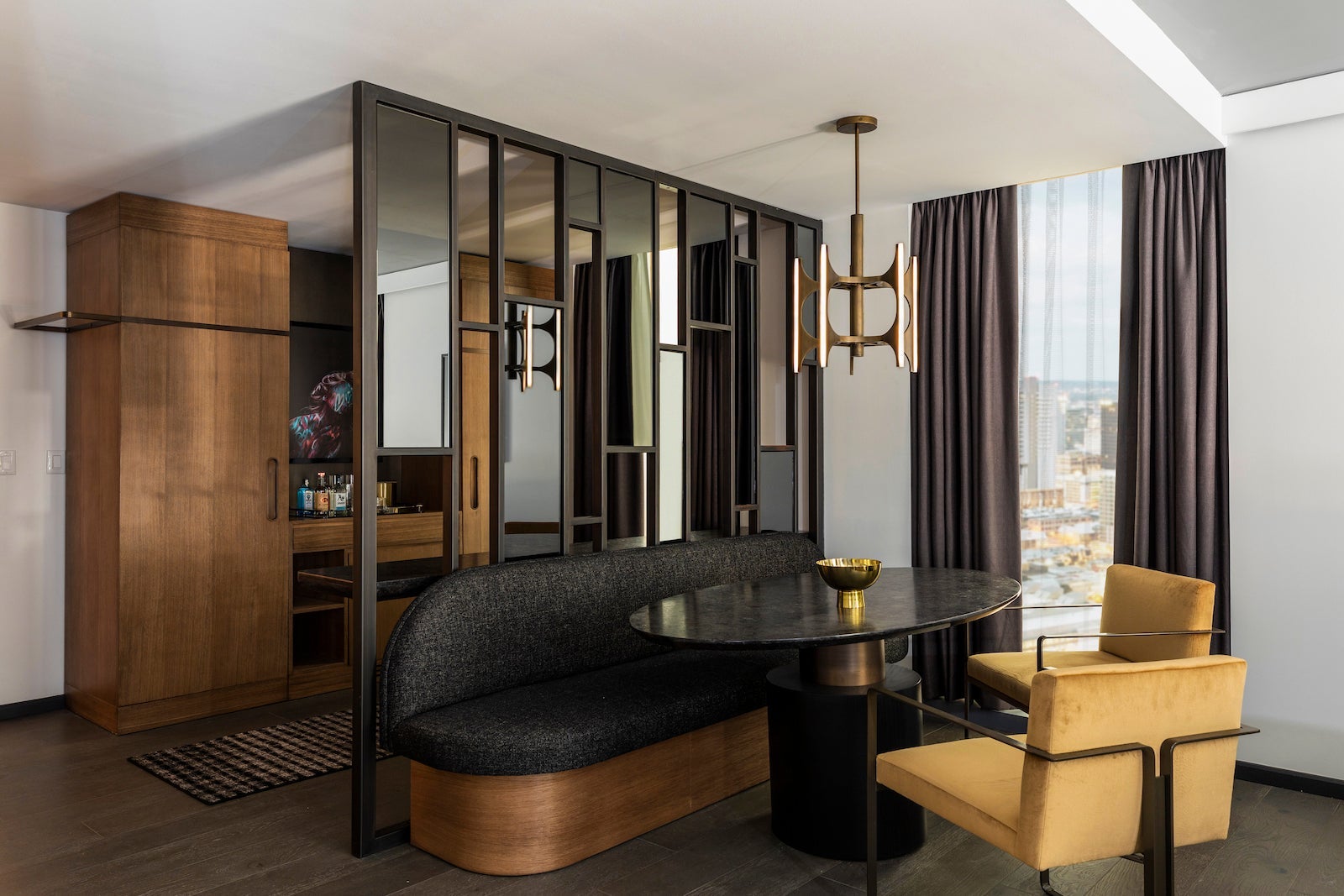 black couch and dining room table with wood-style kitchen