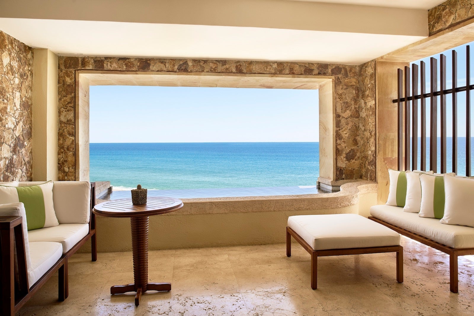 hotel room with plunge pool framing open air space looking out on ocean