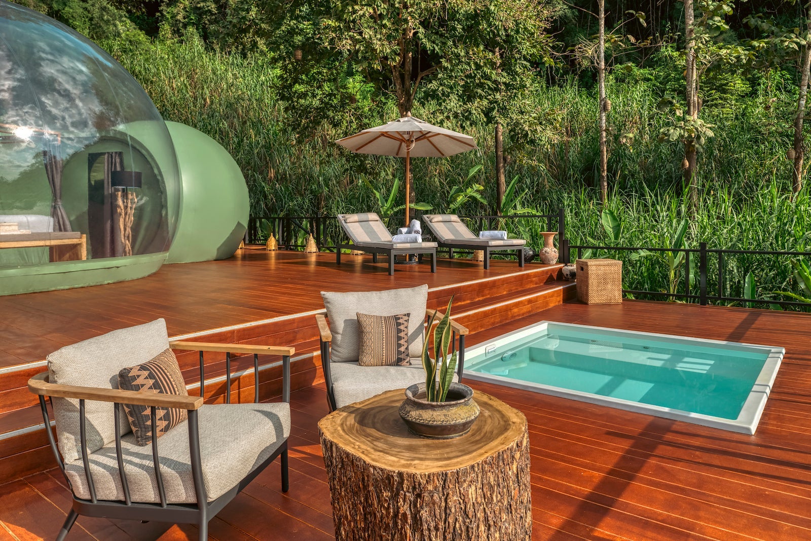 outdoor deck with bubble pods with beds and a plunge pool on the deck