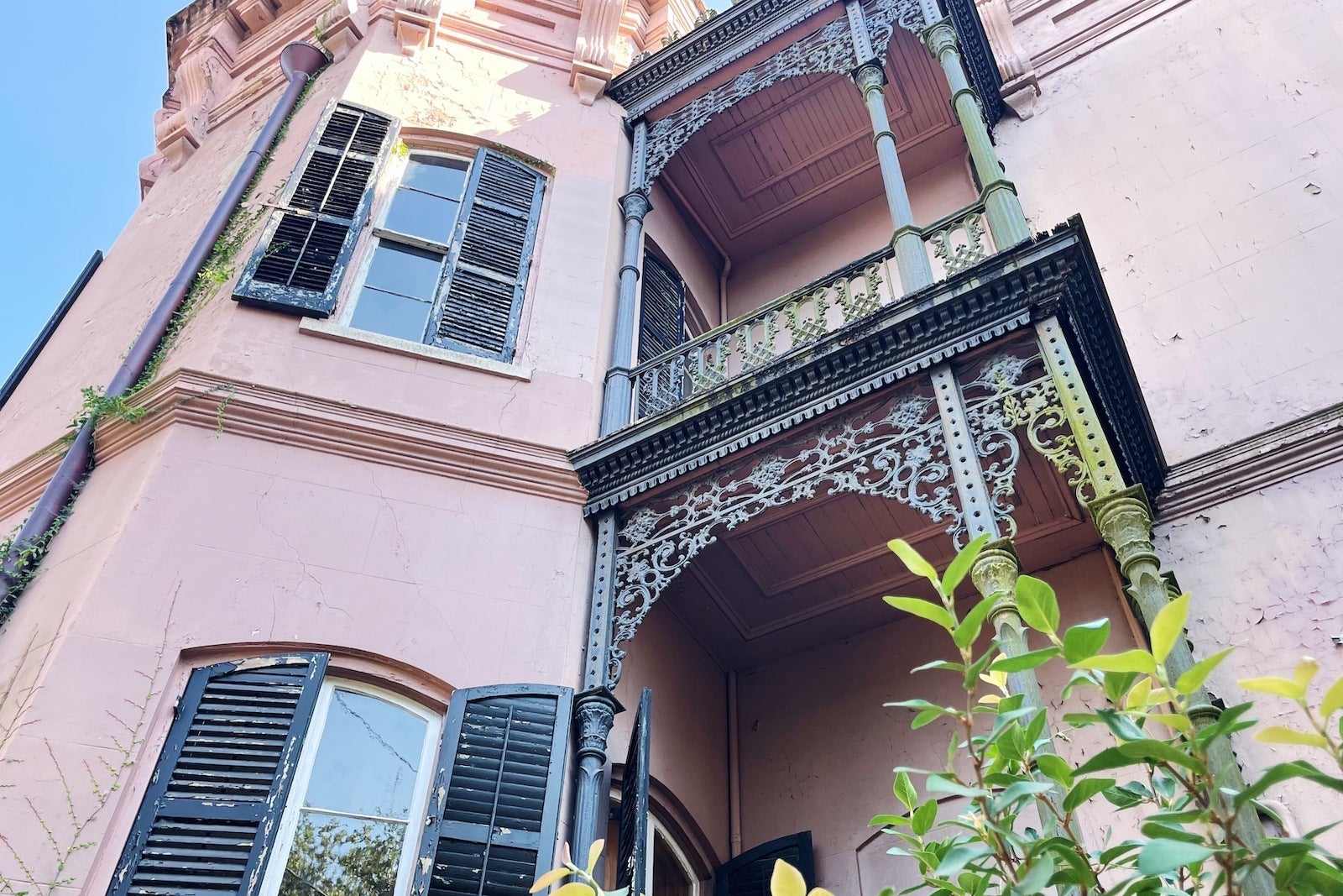 close up of pink house with metal awnings