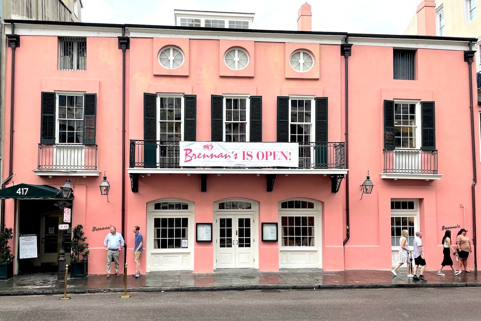 pink building with balcony and banner