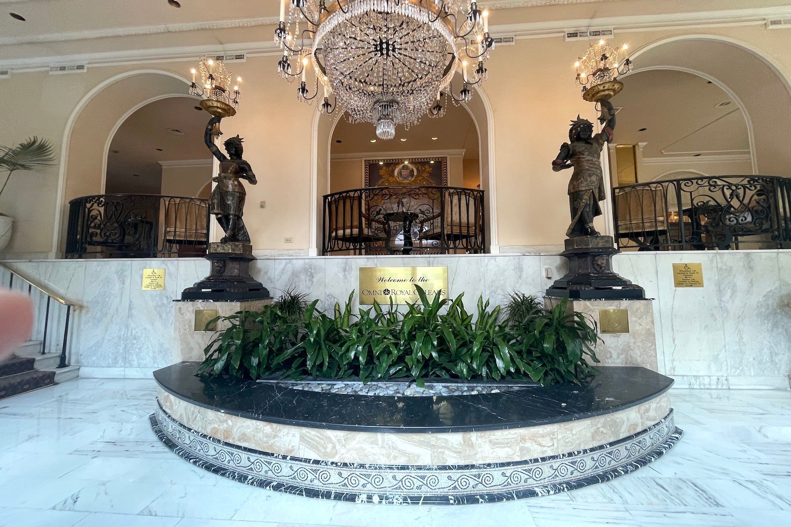 hotel lobby fountain with two statute above