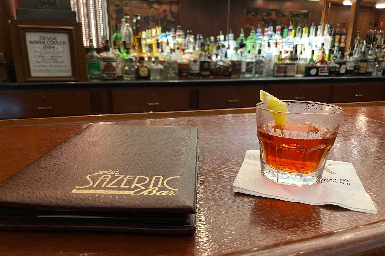 red sazerac cocktail and menu from The Sazerac Bar